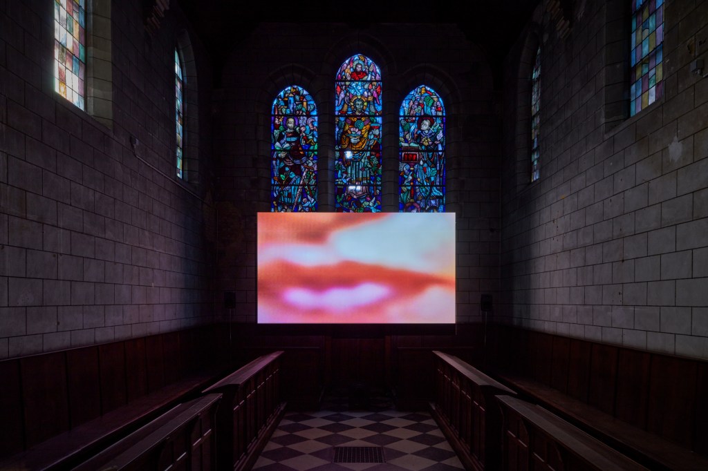 https://youneszarhoni.com/wp-content/uploads/2026/10/silent-times-exhibition-view-2024-kunsthal-extra-city-c-we-document-art_younes-zarhoni-still-from-silence-in-do-2024-2.jpg?w=1024__installation Younes Zarhoni
